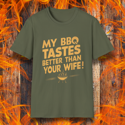 Military Green T-shirt with a bold, cheeky design that reads 'MY BBQ TASTES BETTER THAN YOUR WIFE!' in vintage-style typography, featuring a small flaming grill icon. Perfect for grill masters with a sense of humor.