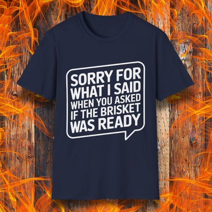 Navy T-shirt with bold white text inside a speech bubble that reads, "Sorry for what I said when you asked if the brisket was ready." A fun and relatable design for BBQ lovers and pitmasters.