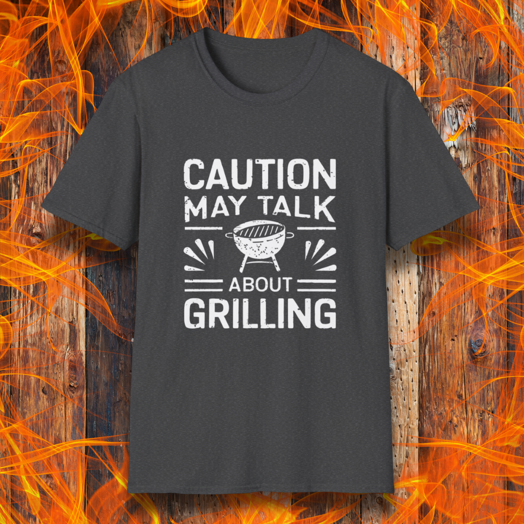 Dark Heather T-shirt featuring bold white text that reads 'CAUTION MAY TALK ABOUT GRILLING,' with a vintage-style BBQ grill illustration and decorative lines. Perfect for passionate grill masters who can't stop talking about barbecue.