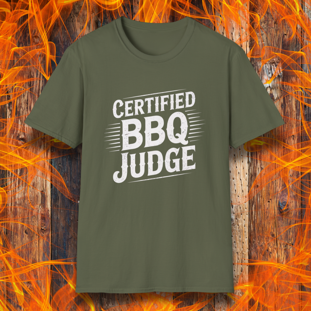 Bold "Certified BBQ Judge" graphic in distressed white text on a military green t-shirt, perfect for BBQ-themed apparel or promotional use.