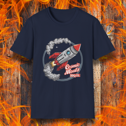 Navy t-shirt featuring a retro-style rocket blasting off with smoke trails, paired with the text 'Cosmic Meats BBQ Co.'—a fun BBQ-themed space design.