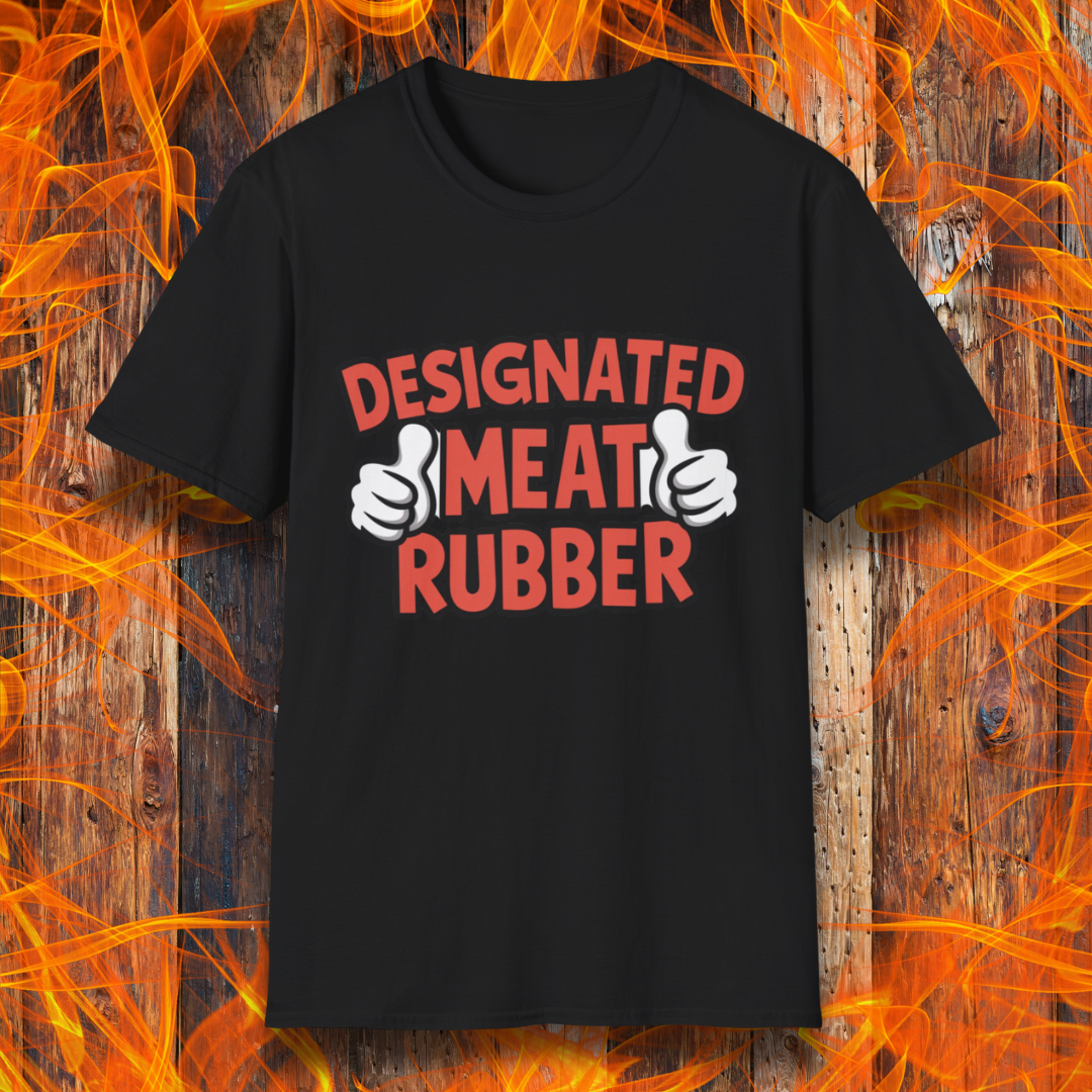 Black T-shirt featuring bold text reading 'Designated Meat Rubber' with two thumbs-up graphics, a humorous BBQ-themed design for grill masters and barbecue lovers.