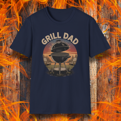 Navy blue t-shirt with 'Grill Dad' graphic on a wooden background with flames.