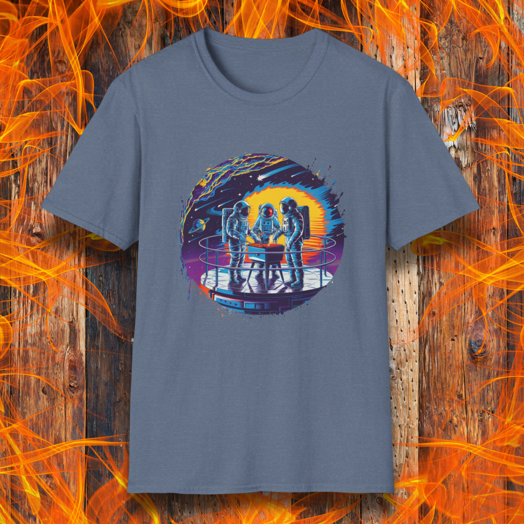 Heather Indigo T-shirt showcases a vibrant, futuristic design featuring astronauts grilling in space. The scene is set on a metallic space station platform, with a cosmic backdrop of planets, stars, and a fiery explosion. The detailed artwork blends sci-fi with BBQ culture, making it a perfect choice for grilling enthusiasts who love a unique, out-of-this-world theme.
