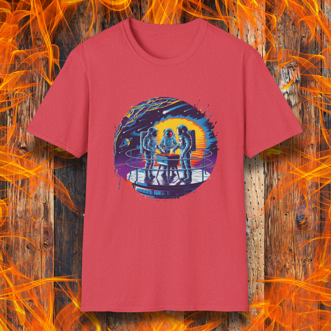 Heather Red T-shirt showcases a vibrant, futuristic design featuring astronauts grilling in space. The scene is set on a metallic space station platform, with a cosmic backdrop of planets, stars, and a fiery explosion. The detailed artwork blends sci-fi with BBQ culture, making it a perfect choice for grilling enthusiasts who love a unique, out-of-this-world theme.