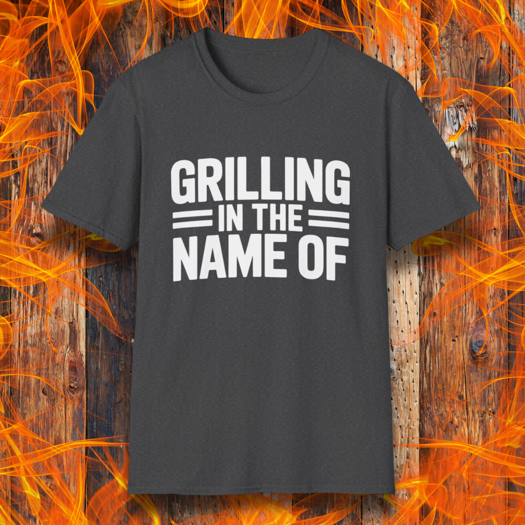 Dark Heather T-shirt with bold white text that reads "Grilling in the Name Of" in a stacked, block-style font — a humorous BBQ-themed shirt for grilling enthusiasts.