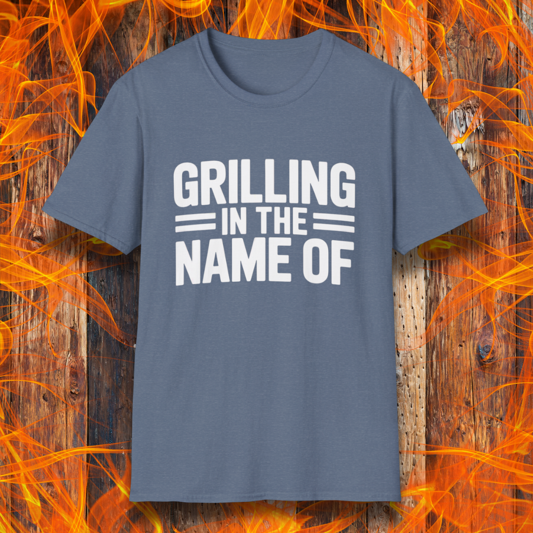 Heather Indigo T-shirt with bold white text that reads "Grilling in the Name Of" in a stacked, block-style font — a humorous BBQ-themed shirt for grilling enthusiasts.