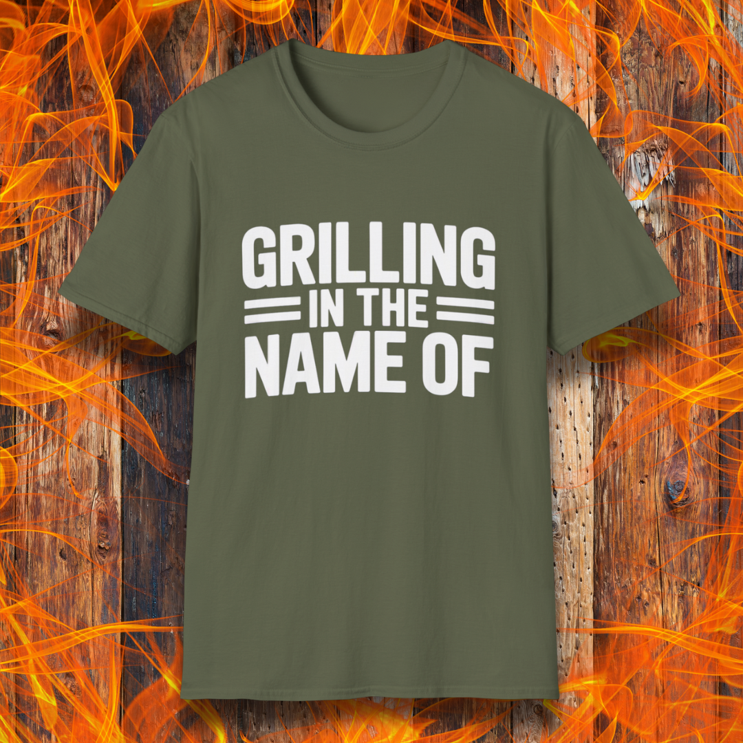 Military Green T-shirt with bold white text that reads "Grilling in the Name Of" in a stacked, block-style font — a humorous BBQ-themed shirt for grilling enthusiasts.
