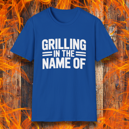 Royal Blue T-shirt with bold white text that reads "Grilling in the Name Of" in a stacked, block-style font — a humorous BBQ-themed shirt for grilling enthusiasts.
