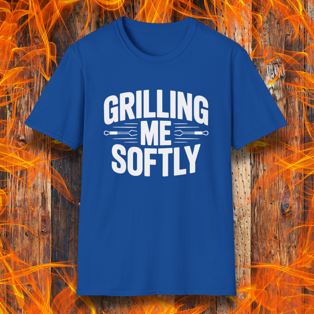 Royal Blue T-shirt with bold white text that says "Grilling Me Softly," featuring BBQ tool graphics between the words — set against a wood and flame background, perfect for grill lovers with a sense of humor.