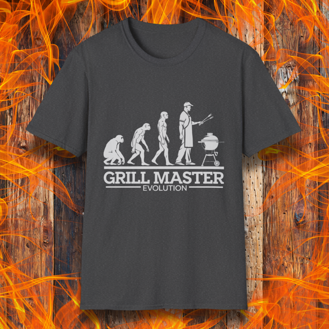 Dark Heather T-shirt featuring a humorous "evolution" design that depicts the progression from primate to modern man, culminating in a grill master holding tongs in front of a BBQ grill. Below the illustration, bold white text reads "GRILL MASTER EVOLUTION," emphasizing the ultimate stage of human development—becoming a master of the grill.