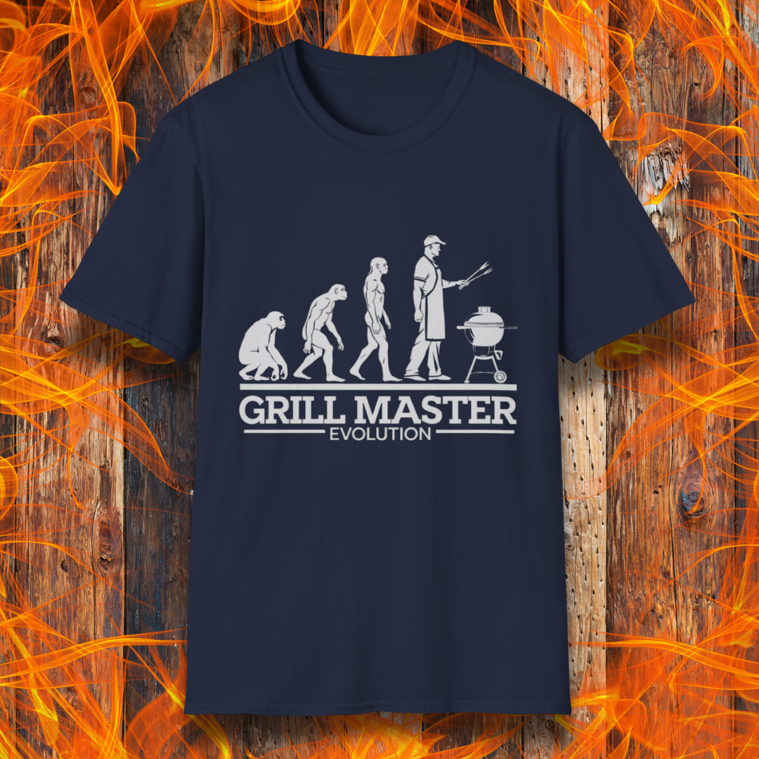 Navy T-shirt featuring a humorous "evolution" design that depicts the progression from primate to modern man, culminating in a grill master holding tongs in front of a BBQ grill. Below the illustration, bold white text reads "GRILL MASTER EVOLUTION," emphasizing the ultimate stage of human development—becoming a master of the grill.