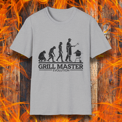 Sport Grey T-shirt featuring a humorous "evolution" design that depicts the progression from primate to modern man, culminating in a grill master holding tongs in front of a BBQ grill. Below the illustration, bold black text reads "GRILL MASTER EVOLUTION," emphasizing the ultimate stage of human development—becoming a master of the grill.