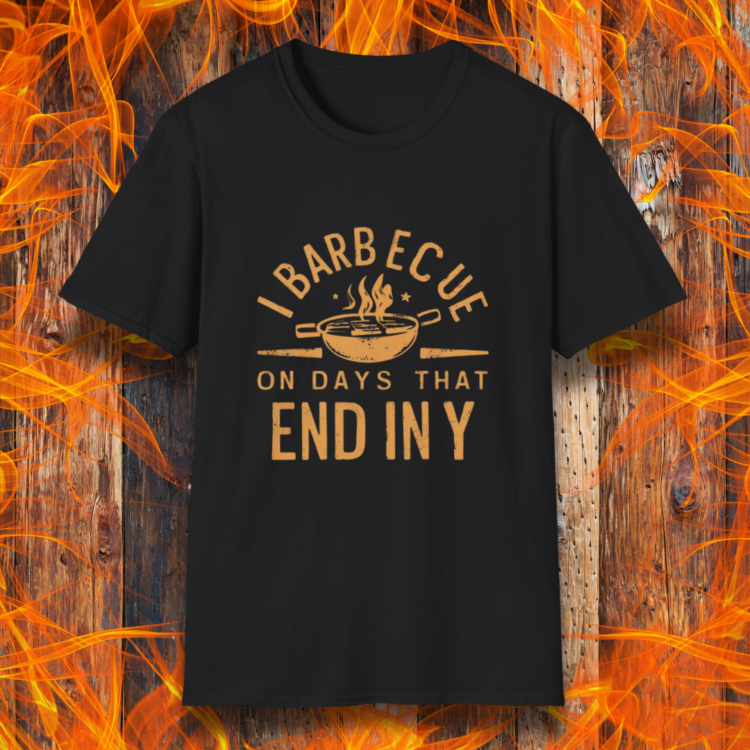 Black T-shirt with 'I Barbecue on Days That End in Y' in bold, rustic orange lettering, featuring a steaming grill pan graphic. Perfect for grill masters who believe every day is BBQ day!