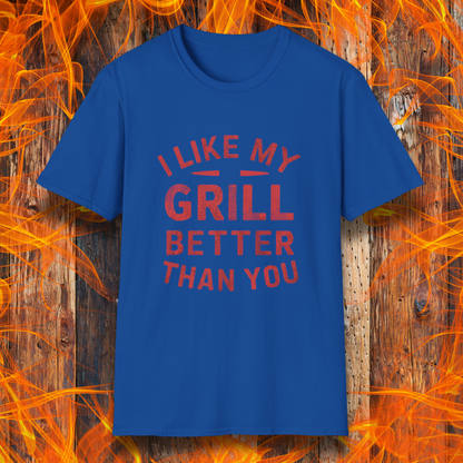 Royal Blue T-shirt with a bold and humorous BBQ-themed design. The red distressed-style text reads 'I Like My Grill Better Than You' in an arched layout, perfect for grill masters who take their barbecue seriously. A fun and stylish shirt for BBQ enthusiasts."