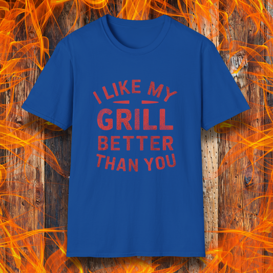 Royal Blue T-shirt with a bold and humorous BBQ-themed design. The red distressed-style text reads 'I Like My Grill Better Than You' in an arched layout, perfect for grill masters who take their barbecue seriously. A fun and stylish shirt for BBQ enthusiasts."