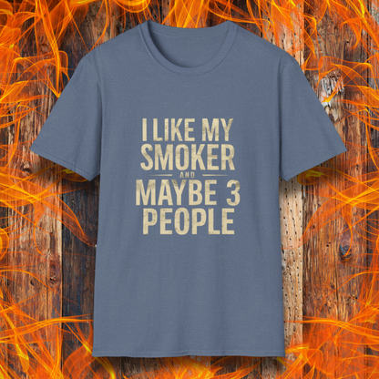 Heather Indigo T-shirt featuring bold, distressed beige text that reads, 'I Like My Smoker And Maybe 3 People.' A humorous BBQ-themed shirt perfect for pitmasters and grilling enthusiasts who prefer the company of their smoker over most people!