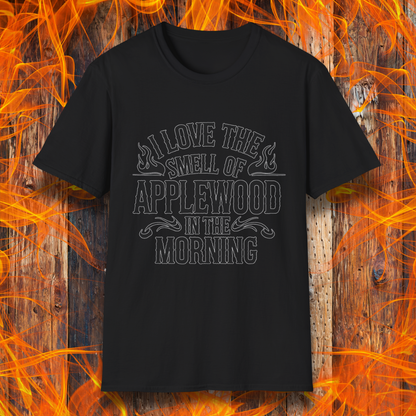 Black T-shirt featuring bold, rustic-style text that says, "I Love the Smell of Applewood in the Morning," with decorative flames. Perfect for BBQ lovers who appreciate the scent of wood-smoked meats.