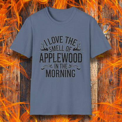 Heather Indigo T-shirt featuring bold, rustic-style text that says, "I Love the Smell of Applewood in the Morning," with decorative flames. Perfect for BBQ lovers who appreciate the scent of wood-smoked meats.