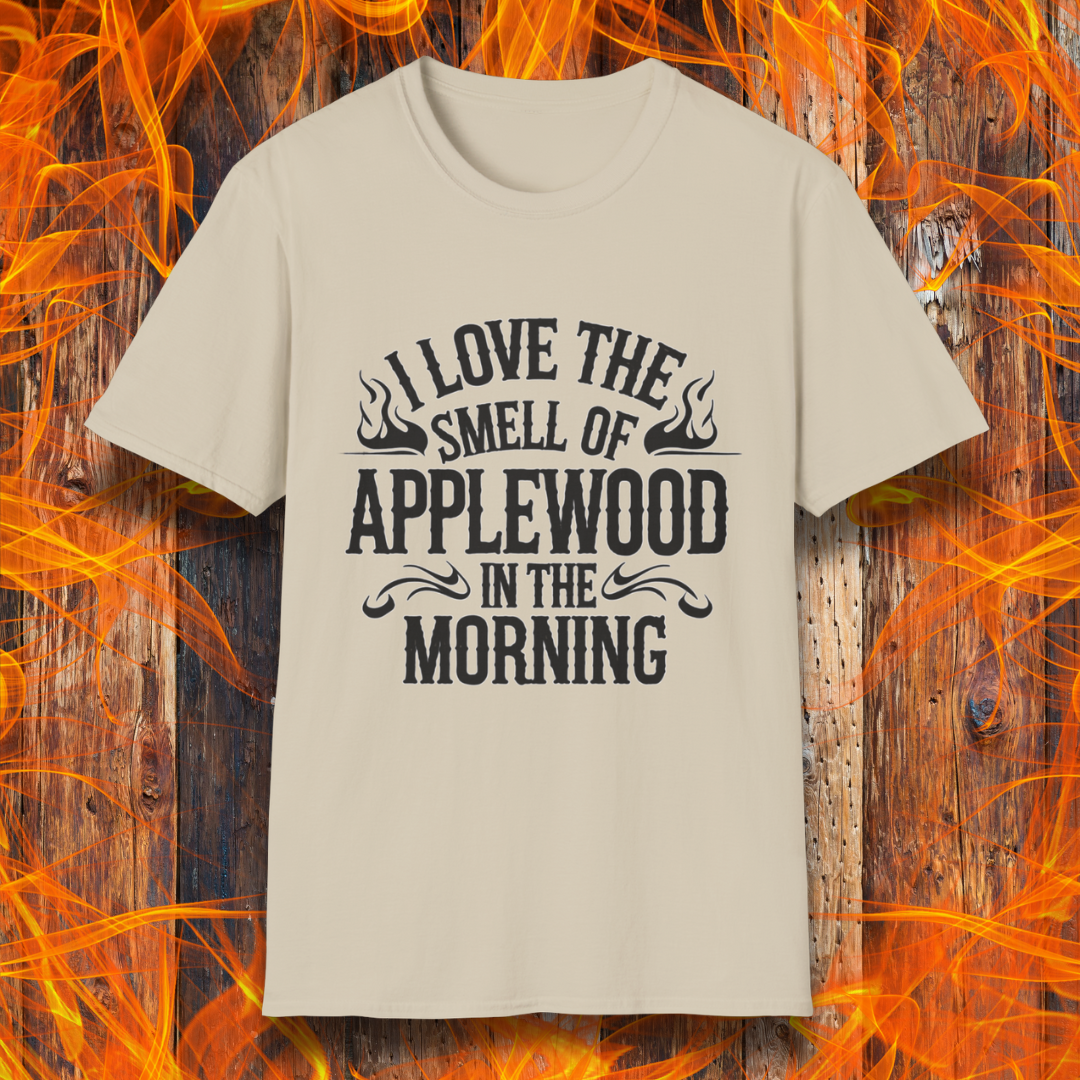 Sand T-shirt featuring bold, rustic-style text that says, "I Love the Smell of Applewood in the Morning," with decorative flames. Perfect for BBQ lovers who appreciate the scent of wood-smoked meats.