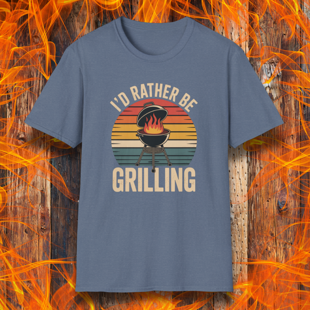 Heather Indigo t-shirt with 'I'd Rather Be Grilling' graphic on a wooden background with flames.