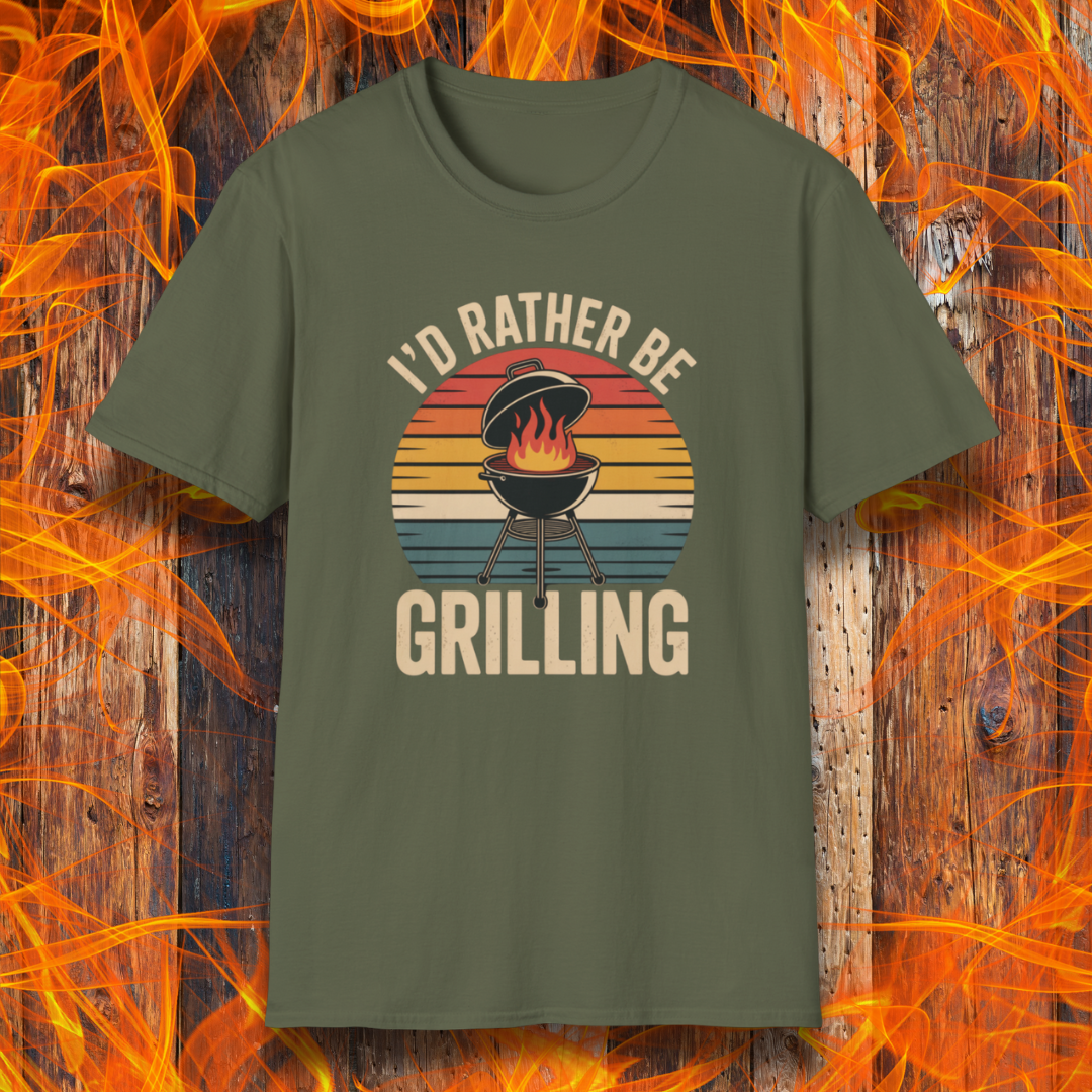 Military Green t-shirt with 'I'd Rather Be Grilling' graphic on a wooden background with flames.