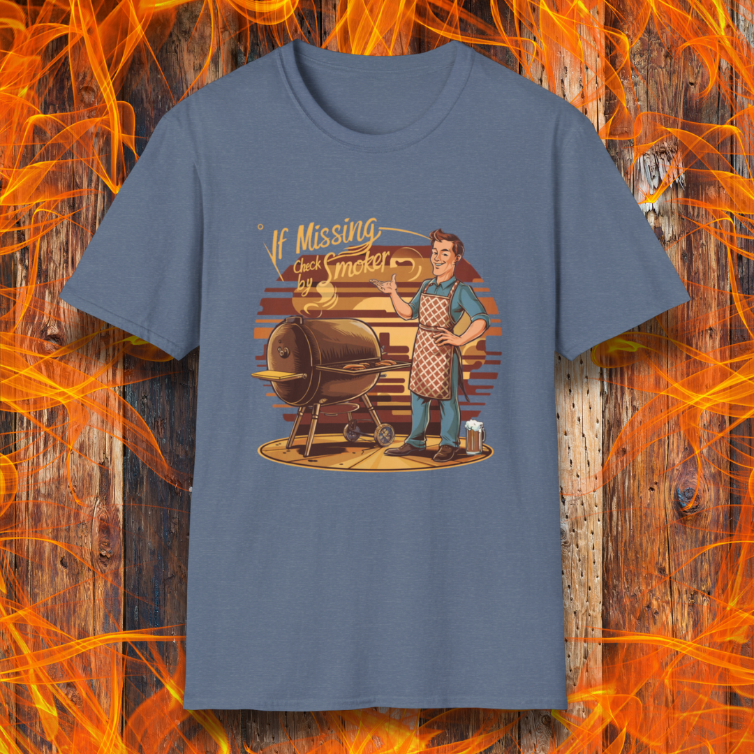 Heather Indigo  t-shirt featuring a retro-style illustration of a man grilling next to a smoker, with the phrase 'If Missing, Check by Smoker,' displayed against a fiery wooden background."