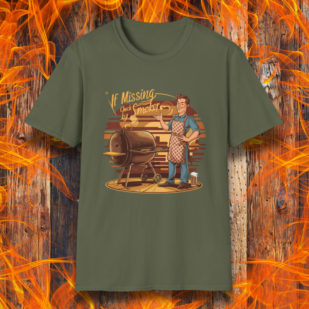 Military Green  t-shirt featuring a retro-style illustration of a man grilling next to a smoker, with the phrase 'If Missing, Check by Smoker,' displayed against a fiery wooden background."