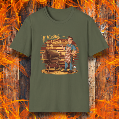 Military Green  t-shirt featuring a retro-style illustration of a man grilling next to a smoker, with the phrase 'If Missing, Check by Smoker,' displayed against a fiery wooden background."