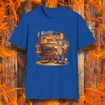 Royal Blue  t-shirt featuring a retro-style illustration of a man grilling next to a smoker, with the phrase 'If Missing, Check by Smoker,' displayed against a fiery wooden background."