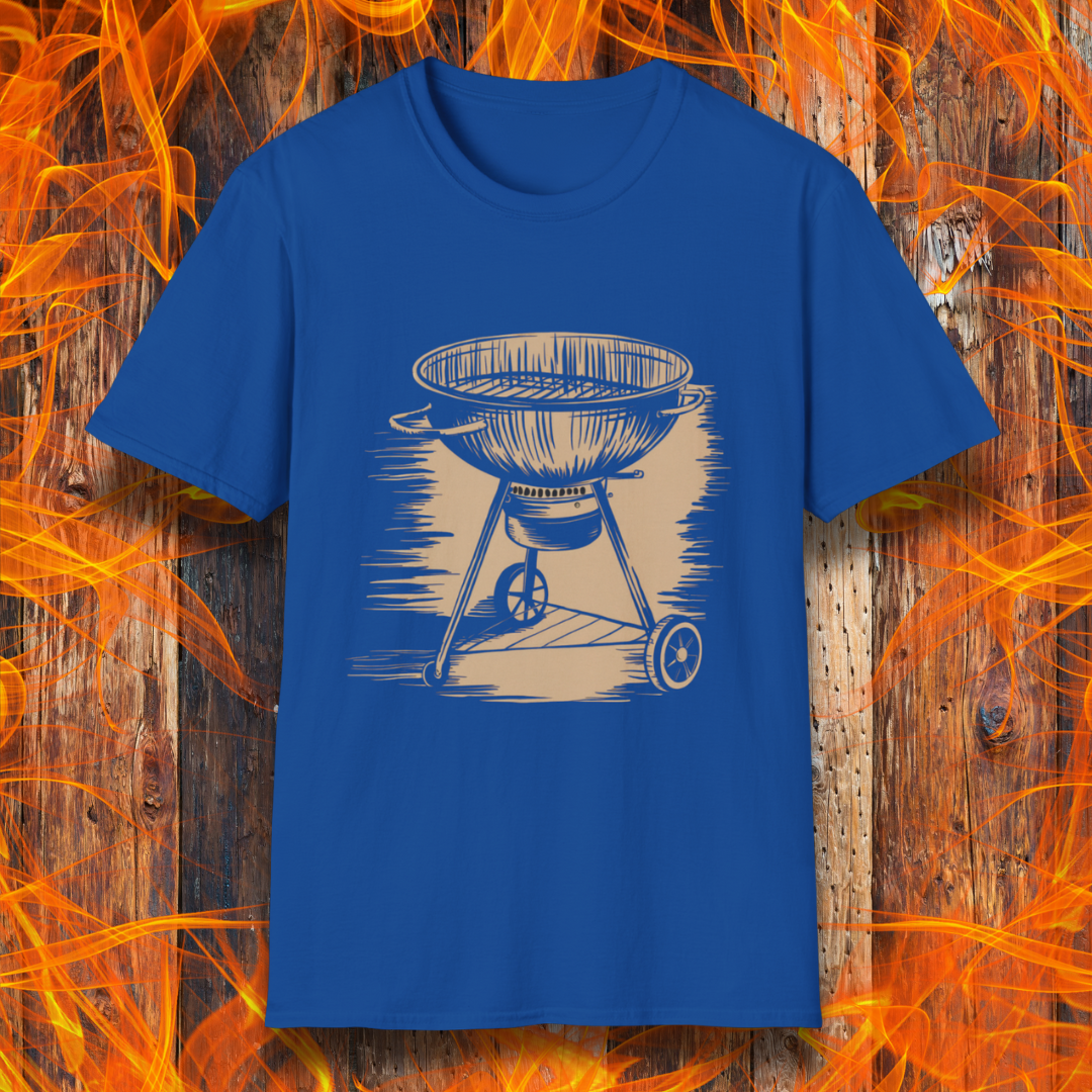 Royal Blue T-shirt featuring a vintage-style beige sketch of a classic charcoal kettle grill. The illustration has a hand-drawn, rustic look with shading lines that add depth and texture. The background consists of a wooden surface with bright orange flames, enhancing the fiery BBQ theme.
