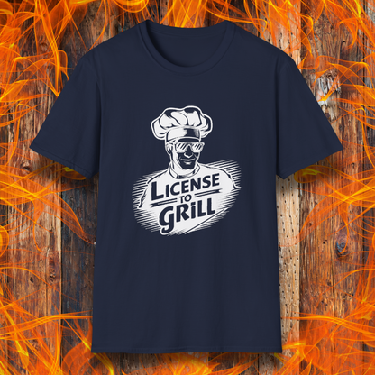 Navy  t-shirt featuring a bold white graphic of a cool chef wearing sunglasses and a toque, with the phrase 'License to Grill' in a dynamic retro-style font.