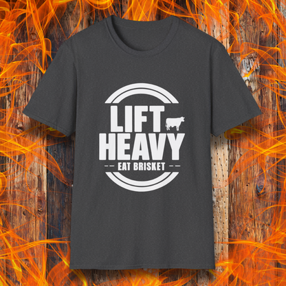 Dark Heather colored T-shirt with "LIFT HEAVY EAT BRISKET" in bold text and a cow silhouette. Perfect for BBQ lovers, gym-goers, and meat-smoking enthusiasts.