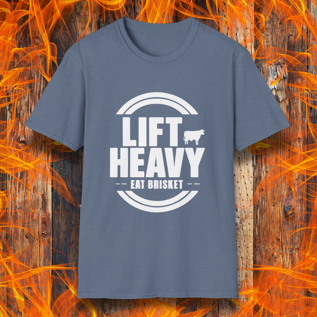Heather Indigo colored T-shirt with "LIFT HEAVY EAT BRISKET" in bold text and a cow silhouette. Perfect for BBQ lovers, gym-goers, and meat-smoking enthusiasts.