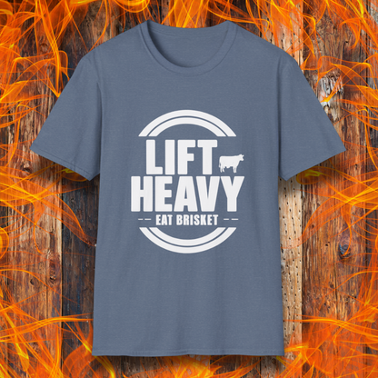 Heather Indigo colored T-shirt with "LIFT HEAVY EAT BRISKET" in bold text and a cow silhouette. Perfect for BBQ lovers, gym-goers, and meat-smoking enthusiasts.