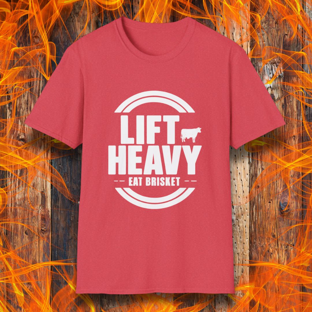 Heather Red colored T-shirt with "LIFT HEAVY EAT BRISKET" in bold text and a cow silhouette. Perfect for BBQ lovers, gym-goers, and meat-smoking enthusiasts.