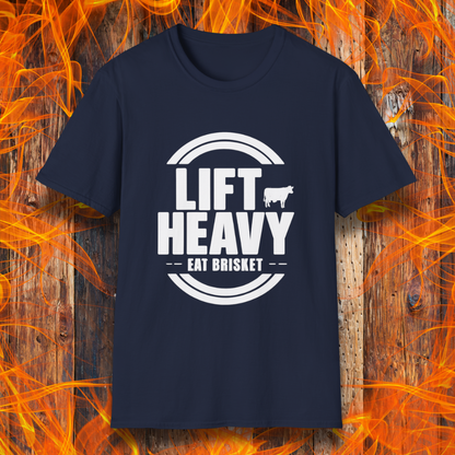 Navy colored T-shirt with "LIFT HEAVY EAT BRISKET" in bold text and a cow silhouette. Perfect for BBQ lovers, gym-goers, and meat-smoking enthusiasts.