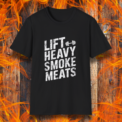 Black T-shirt with bold, distressed white text reading 'Lift Heavy Smoke Meats,' featuring a barbell icon. A perfect fit for BBQ lovers and gym enthusiasts who take their grilling and gains seriously!