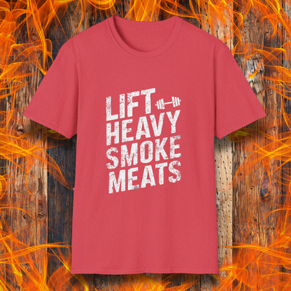 Heather Red T-shirt with bold, distressed white text reading 'Lift Heavy Smoke Meats,' featuring a barbell icon. A perfect fit for BBQ lovers and gym enthusiasts who take their grilling and gains seriously!