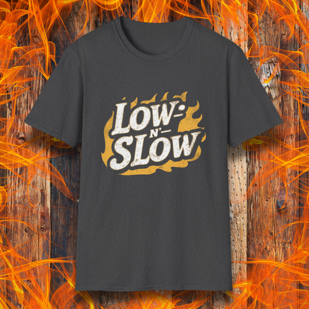 Dark Heather  T-shirt featuring 'Low-N-Slow' in bold, distressed lettering over a fiery background. Perfect for BBQ pitmasters who know that great barbecue takes time!