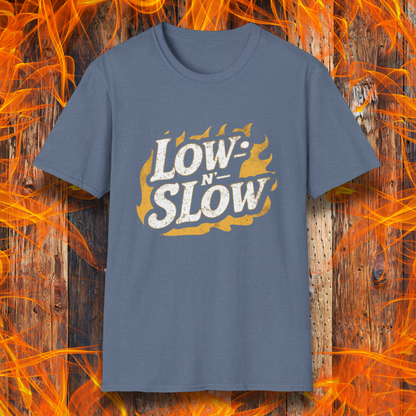 Heather Indigo T-shirt featuring 'Low-N-Slow' in bold, distressed lettering over a fiery background. Perfect for BBQ pitmasters who know that great barbecue takes time!
