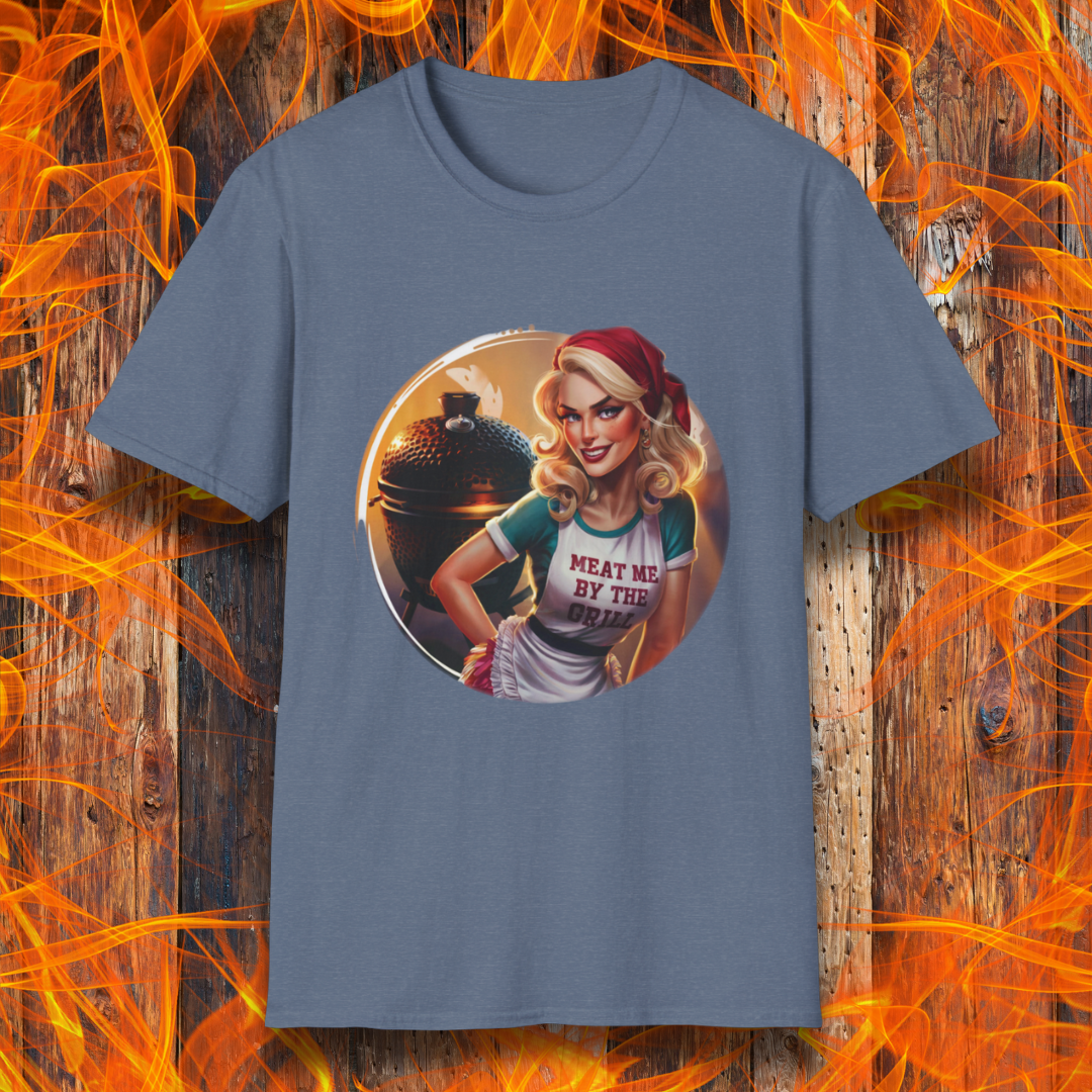 Heather Indigo t-shirt featuring a vintage-inspired pin-up style woman in front of a charcoal grill, wearing an apron that reads 'Meat Me By The Grill.
