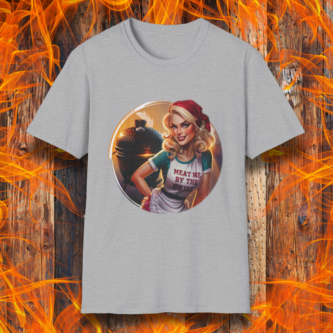 Sport Grey t-shirt featuring a vintage-inspired pin-up style woman in front of a charcoal grill, wearing an apron that reads 'Meat Me By The Grill.'"