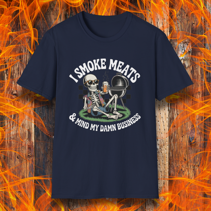 Navy blue t-shirt with skeleton graphic and text 'I Smoke Meats & Mind My Damn Business' on a fiery background.