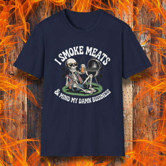 Navy blue t-shirt with skeleton graphic and text 'I Smoke Meats & Mind My Damn Business' on a fiery background.