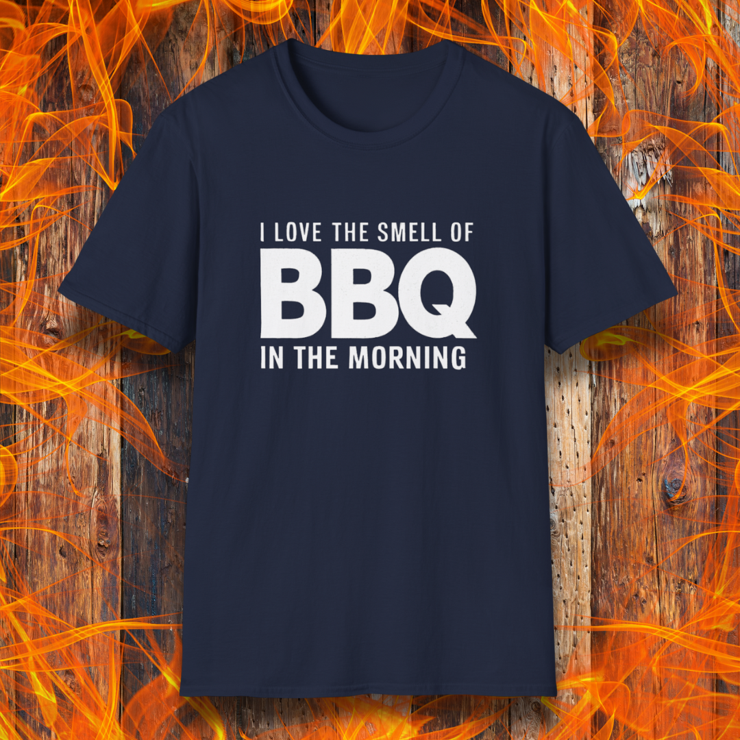 Navy t-shirt with the phrase 'I Love the Smell of BBQ in the Morning' in bold white text, displayed against a fiery wooden background