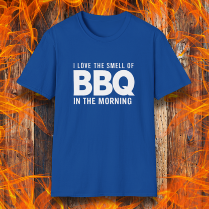 Royal Blue t-shirt with the phrase 'I Love the Smell of BBQ in the Morning' in bold white text, displayed against a fiery wooden background