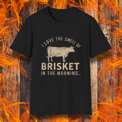 Black T-shirt featuring vintage-style text that reads 'I Love the Smell of Brisket in the Morning,' along with a rustic, hand-drawn cow illustration. A must-have for BBQ lovers and brisket enthusiasts!