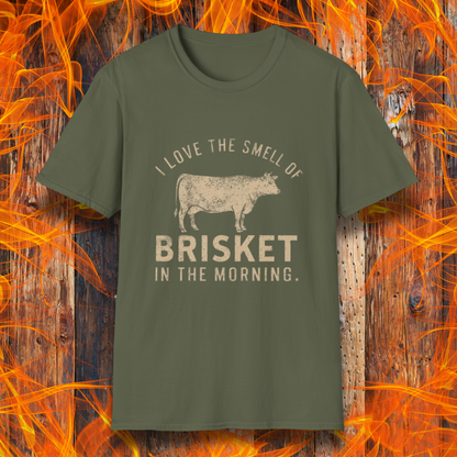 Military Green T-shirt featuring vintage-style text that reads 'I Love the Smell of Brisket in the Morning,' along with a rustic, hand-drawn cow illustration. A must-have for BBQ lovers and brisket enthusiasts!