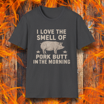 Dark Heather T-shirt with bold beige text reading 'I Love the Smell of Pork Butt in the Morning,' featuring a vintage-style pig illustration and star accents. Perfect for BBQ enthusiasts and pitmasters!